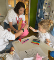 Radio Lollipop Volunteers and child colouring in
